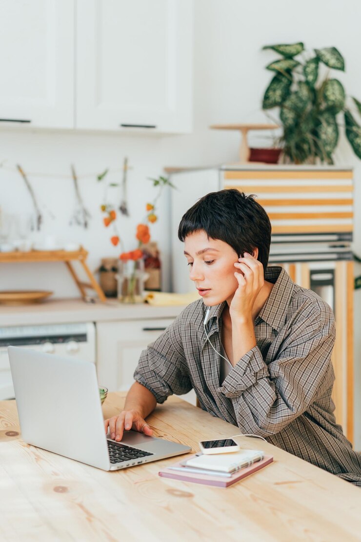 concentrated-female-student-studying-laptop-listening-audio-headphones-home_1048944-22272701